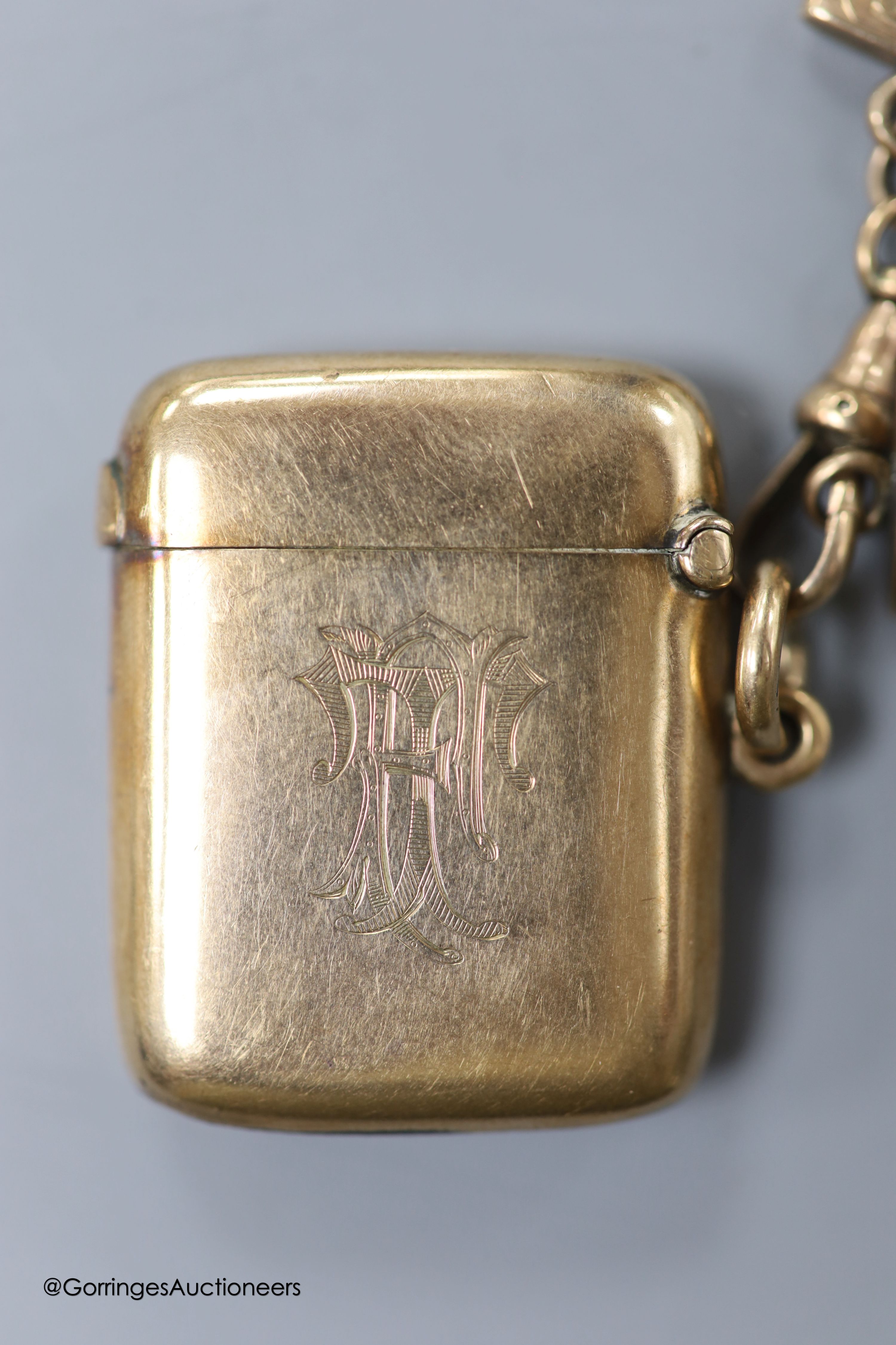 A late Victorian 9ct gold vesta case, William Neale, Chester, 1899, 40mm, with two hair mounted fobs